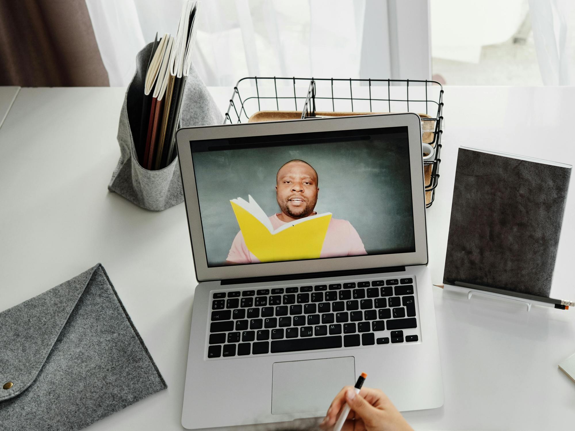 school age girl takes online classes at home via her laptop