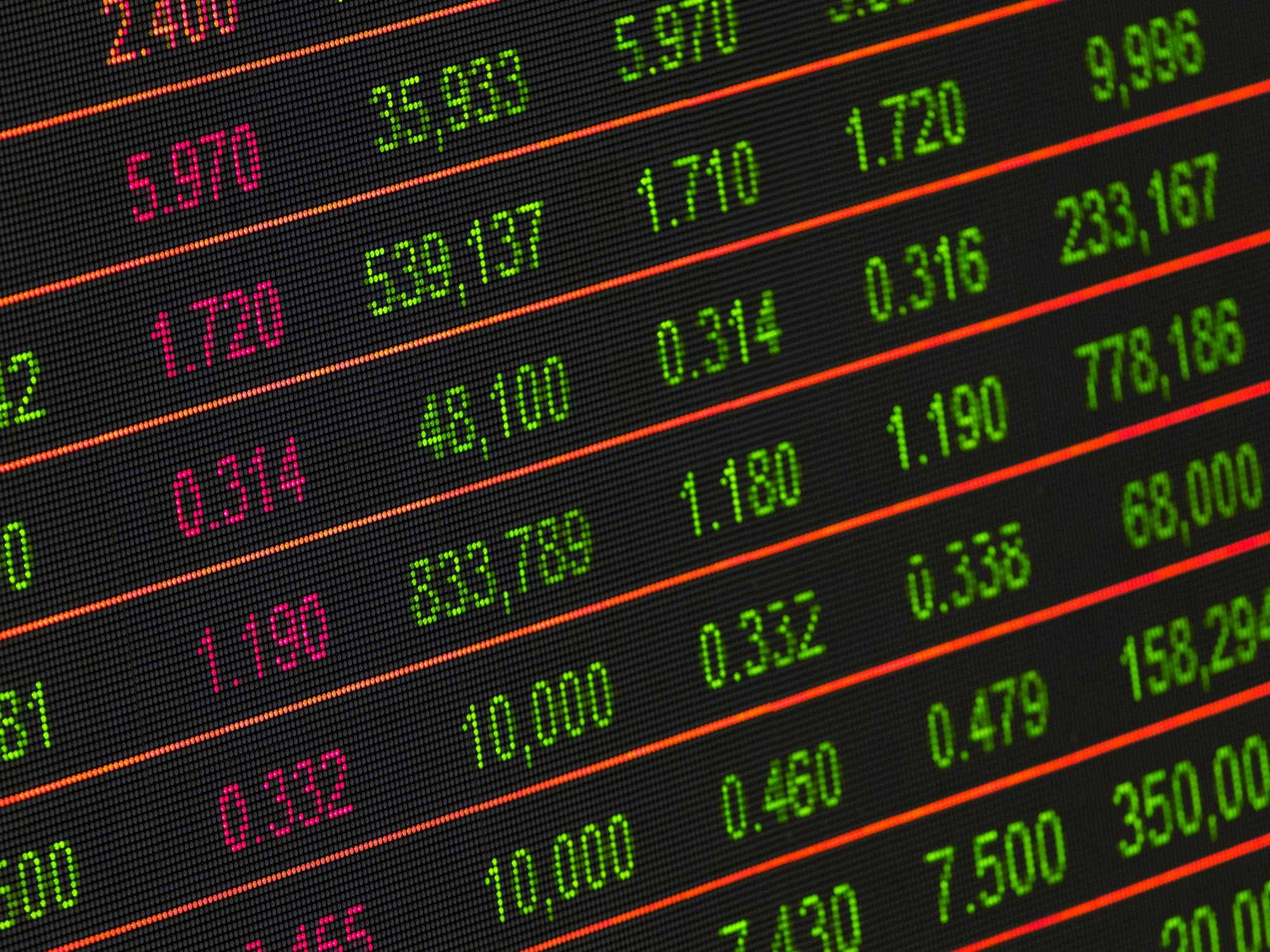 stocks being shown on a panel.