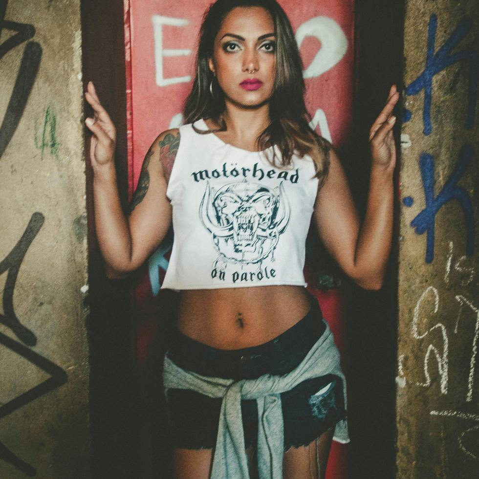 Young woman posing for a picture among city grafitti.